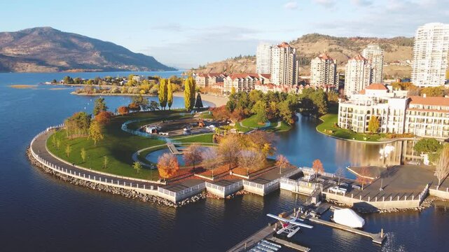 Downtown Waterfront, Kelowna, BC, Canada. Calm Okanagan Lake Landscape. British Columbia Interior in the Fall Autumn Season with Colourful Trees Shedding Leaves. Evening Sunset, City Park Walking Path