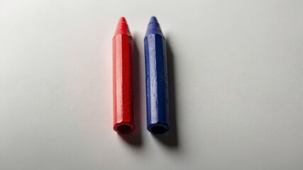 Red and Blue Crayons on a White Surface
