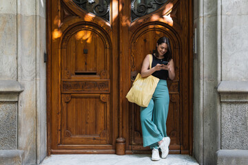 Obraz premium Pretty young woman using her smartphone while waiting a friend