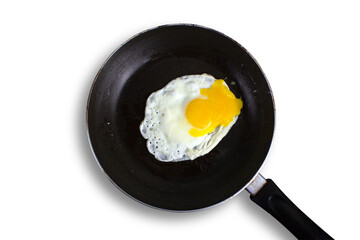 Fried eggs are fried in a black oily pan in isolated white background