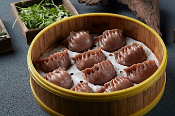 Freshly steamed buckwheat dumplings with vegetarian filling in a steamer