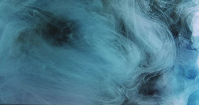 Paint mist. Smoke texture. Defocused blue color fog splash wave floating underwater flow motion on dark abstract art background.