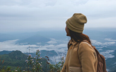 Blurred of a woman looking at a beautiful mountain views and the sea of fog