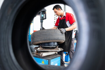 Tire Change Through the Tire: A close-up, unique perspective through a tire's center, showing a...