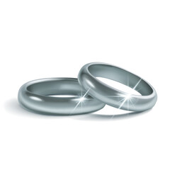 A pair of simple, shiny, polished silver wedding rings lying on a white background, symbolize unity and love. With glares and soft shadows.