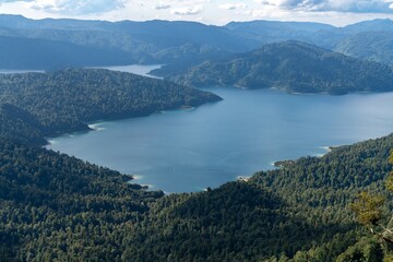 High angle view of a serene Lake Waikaremoana nestled amongst lush, green mountains. Tranquil landscape. Lake Waikaremoana Track, Hawkes Bay, New Zealand