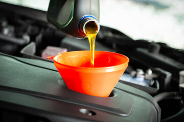 Refueling and pouring oil quality into the engine motor car Transmission and Maintenance...