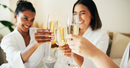 Hands, friends and champagne for toast at spa, relax and happy for reunion, bonding or diversity at resort. People, girl and group with glasses, drinks or alcohol for cheers in hotel room on vacation