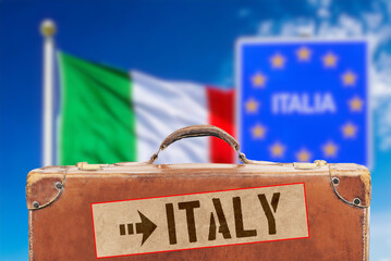 Italian flag, a suitcase and destination Italy