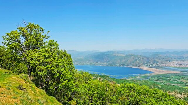 Stunning view of Marivan city with Zagros forests and Lake Zarivar under a clear blue sky.
📍Marivan - Kurdistan