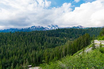 Mountainous landscape with cloudy sky. Scenic green hill mountain. Stunning natural views. Summer day in wild mountain with coniferous forest and green slopes. Mountain landscape with meadow