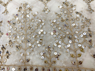 delicate geometric sequin floral butta graces soft white georgette, shimmering elegantly with every movement.