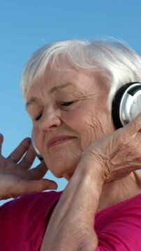 Senior woman listening music