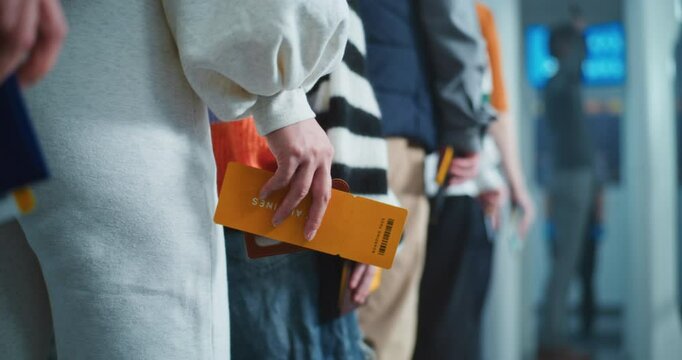 Airport Security Checkpoint: Queue of Passengers, Travelers Standing for Metal Detector Scanning Gates with Tickets and Documents in Hands. Diverse People Undergoing TSA Screening Procedures. Close Up