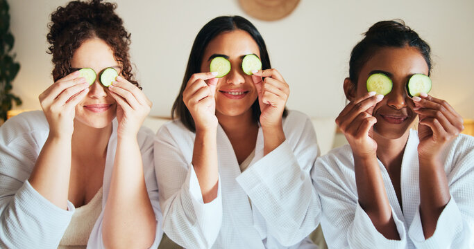 Skincare, friends and happy women with cucumber for beauty, dermatology or organic wellness at home spa. Girls, vegetable slice and together for facial treatment, cosmetics and pamper at sleepover