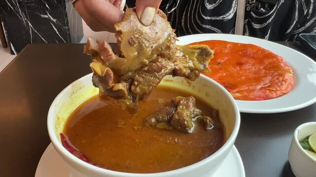Closeup view of mutton pieces in shahi mutton Kundan korma with shirmal paratha