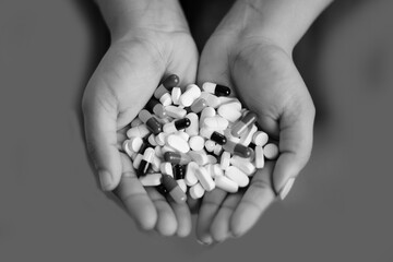 pills in hand black and white image