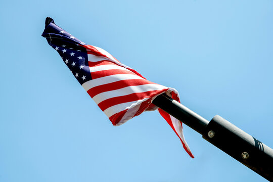 Flag of the United States of America isolated on blue sky waving in spring