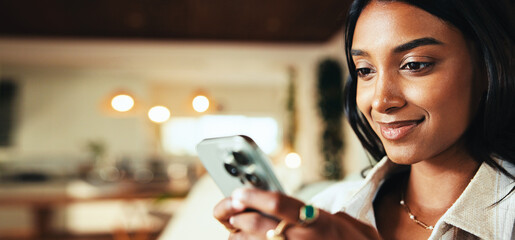 Woman, phone and happy on couch in home, chat and search for valentines day date in lounge. Girl, person and smile with mobile app, typing or check notification on social network on sofa at apartment