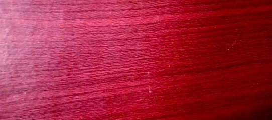 Red Polished Wooden Surface with Fine Grain.A deep red polished wooden surface with fine wood grain, giving a luxurious and elegant feel.