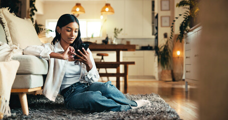 Woman, phone and relax in home with social media, reading blog and ecommerce at sofa. Girl, scroll...
