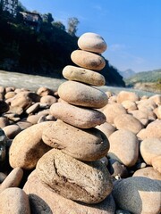 Balanced Serenity: Stacked Stones by the River