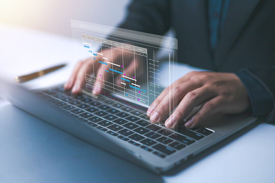 Businessman marking the schedule. Businessman using laptop create a calendar program, rganize and schedule activity and event planner, a calendar page shows on laptop, scheduler, date appointing