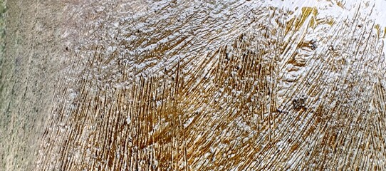 Close-up of wood texture with natural grain.A close-up of rough wooden texture with visible natural grain and scratches, showcasing a rustic and aged surface detail.  