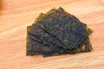 The shape and texture of dried Nori seaweed that is ready to eat immediately, with a close-up view.