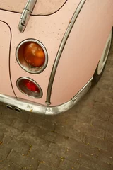 Gordijnen Pink vintage car taillights parked on brick road © Cavan