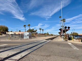Railroad crossing in Wickenburg, AZ with signal lights, palm trees