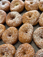 Sprinkle the golden brown donuts with powdered sugar, decorate with filling or sweet jam on top and serve.
