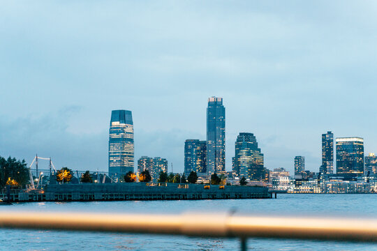 City skyline at dusk with modern architecture reflecting on wate