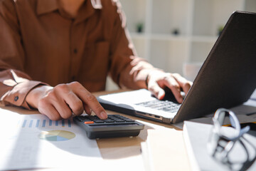 Accountant working on financial calculations using a calculator