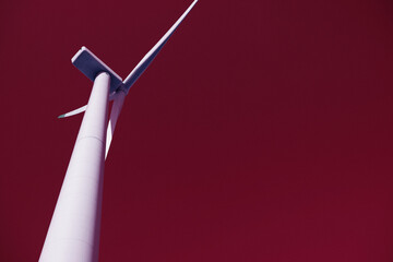 Wind turbine against the surreal red sky