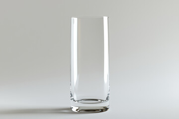A Tall Glass Vase Resting on a Soft Gray Surface.