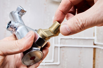 Threaded brass eccentric dog leg type reducer attaches to bathtub shower faucet.