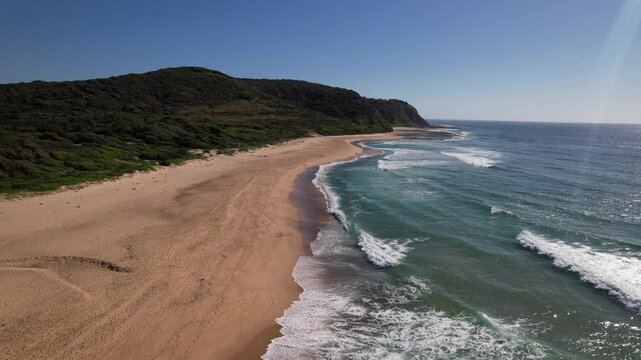 Sea Waves Splashing Sandy Shore Of Glenrock Beach In Merewether, NSW, Australia - Aerial Shot