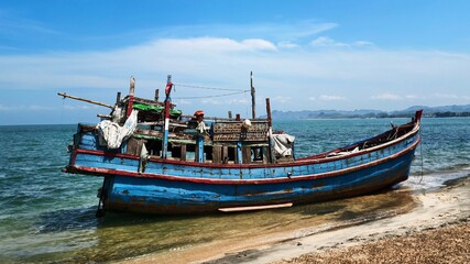 Weathered Wooden Fishing Boat Beached on a Tropical Shore