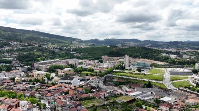 Aerial - Panoramic view of Guimar&atilde;es, Portugal, featuring Est&aacute;dio D. Afonso Henriques, cityscape, and rolling green hills
