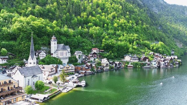 Hallstatt Town Along The Lake In Daytime With Verdant Forest In The Mountain In Austria. - aerial shot