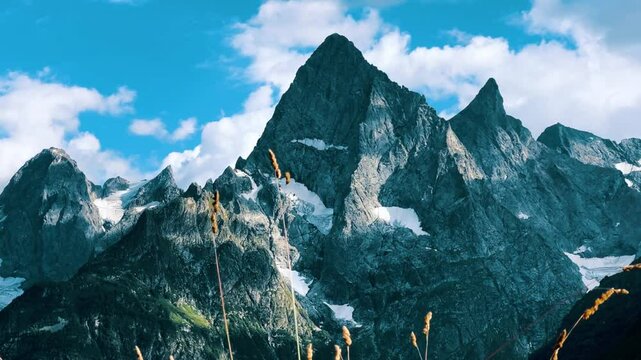 Teberdinsky Nature Reserve. View of Kosygin's glade in the Gonachkhir gorge and the top of Dombai-Ulgen mountain near Lake Tumanly-Kel on a sunny summer day. Panoramic landscape. Resort. 4K