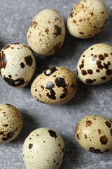 Quail eggs on gray background