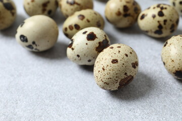 Quail eggs on gray background