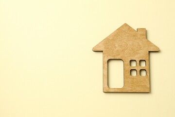 Wooden house on color background