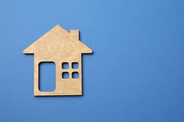 Wooden house on color background