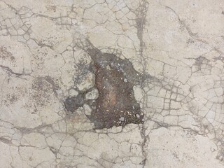 Cracked concrete surface with a hole in the middle