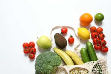 String bag with vegetables and fruits on white background
