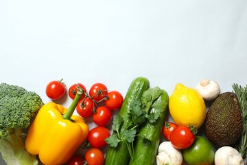 Clean healthy eating habits concept. Fruits, herbs, greens and vegetables mix, colorful juicy organic detox smoothie juice ingredients, gray background. Vegan vegetarian diet food