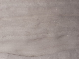 A grey surface with a lot of white specks